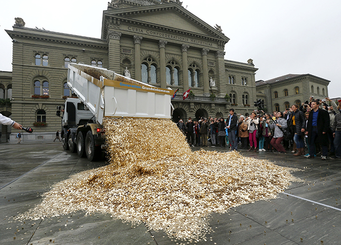 Truck dumps five cent coins in the centre of the Federal Square during event organised by Committee for initiative Grundeinkommen in Bern